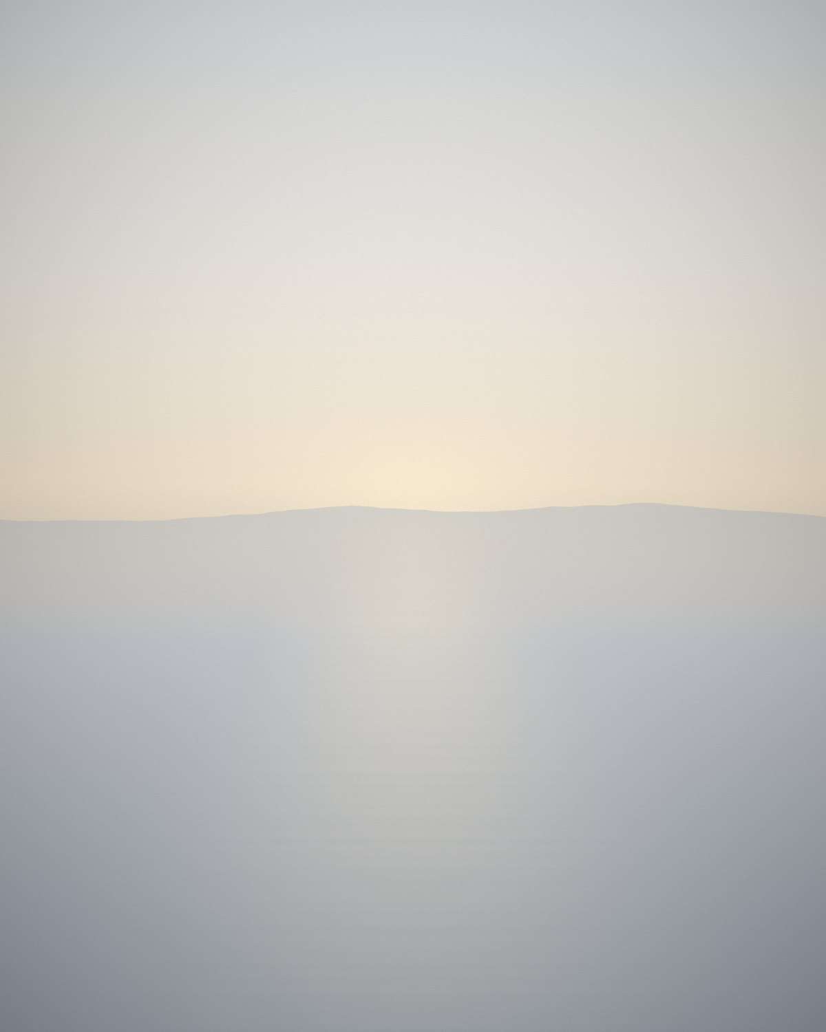 Still water meeting the sky at first light